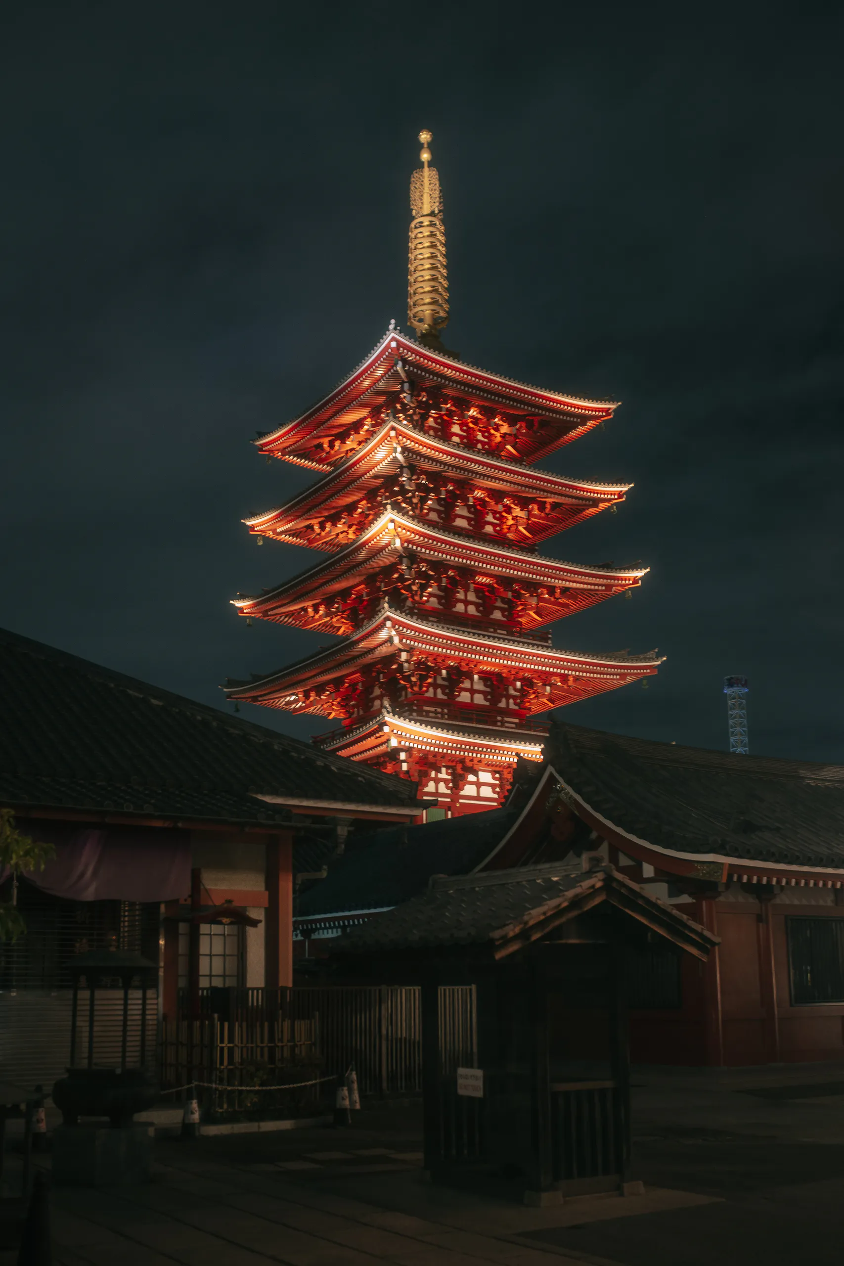 The five-storey pagoda of Sensō-ji lit in red at night